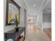 Elegant foyer featuring a console table with fresh flowers and a view to the expansive living spaces at 1208 Anora Dr, Apex, NC 27502