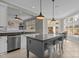 Open-concept kitchen with granite island, stainless steel dishwasher, and adjacent dining area at 1208 Anora Dr, Apex, NC 27502