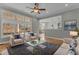 Cozy living room with large windows and hardwood floors, great for entertaining at 1208 Anora Dr, Apex, NC 27502