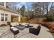 Outdoor patio with wicker furniture, a modern fire pit, and a paved surface, ideal for entertaining at 1208 Anora Dr, Apex, NC 27502