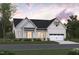 Charming modern farmhouse with white siding, black roof, and inviting front porch at 1212 Opal Ln # 91, Durham, NC 27705