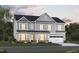 Charming two-story home with light blue siding, black roof, and well-manicured lawn at 1216 Opal Ln # 90, Durham, NC 27705