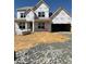 New construction featuring a two-story home design, showcasing a spacious garage and modern architectural elements at 1220 Opal Ln # 89, Durham, NC 27705