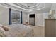 Bedroom with a large window, flat screen TV, decorative tray ceiling and a ceiling fan at 149 Winterberry St, Clayton, NC 27527