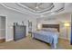 Bright bedroom with decorative tray ceiling, ceiling fan and ensuite bathroom at 149 Winterberry St, Clayton, NC 27527