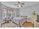 Inviting bedroom with large windows, hardwood floors, and a ceiling fan at 149 Winterberry St, Clayton, NC 27527