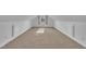 This bonus room features a dormer window providing natural light, and neutral colored carpeting at 149 Winterberry St, Clayton, NC 27527