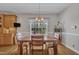 A dining area with a wooden table, chairs, and a large window at 149 Winterberry St, Clayton, NC 27527