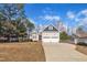 Inviting home showcasing a two-car garage, manicured lawn, and charming exterior details at 149 Winterberry St, Clayton, NC 27527