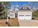 Charming two-story home with attached two-car garage, manicured lawn, and classic architectural details at 149 Winterberry St, Clayton, NC 27527
