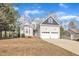 Inviting two-story home featuring a two-car garage, brick-lined driveway, and well-maintained landscaping at 149 Winterberry St, Clayton, NC 27527