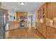 A modern kitchen with wooden cabinets, stainless steel appliances, and hardwood floors at 149 Winterberry St, Clayton, NC 27527