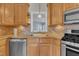 The kitchen features wooden cabinets, stainless steel appliances, and a sink under the window at 149 Winterberry St, Clayton, NC 27527