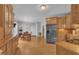 A kitchen and dining area with stainless steel refrigerator and view into dining area at 149 Winterberry St, Clayton, NC 27527