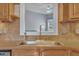 A close-up of the kitchen sink and window showing a view of the outside at 149 Winterberry St, Clayton, NC 27527