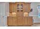Built-in wooden cabinetry with glass door upper cabinets and lighting underneath at 149 Winterberry St, Clayton, NC 27527