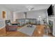 Bright living room with hardwood floors, grey walls, and large windows for plenty of natural light at 149 Winterberry St, Clayton, NC 27527