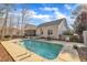 Beautiful in-ground pool surrounded by a concrete patio and well-maintained landscaping at 149 Winterberry St, Clayton, NC 27527