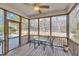 This screened porch features wood decking, an outdoor table and chairs, and a view of the pool at 149 Winterberry St, Clayton, NC 27527