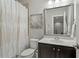 Bathroom featuring a vanity with a sink, a toilet, and a shower with a curtain at 1608 Doubles Ct, Raleigh, NC 27609
