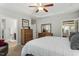 Bright bedroom with neutral tones, trey ceiling, and furnishings including dressers, sitting chair, and artwork at 1608 Doubles Ct, Raleigh, NC 27609