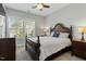 Bedroom featuring a bed with a dark wood frame and a window with blinds at 1608 Doubles Ct, Raleigh, NC 27609