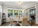 Sunlit breakfast nook with large windows and views of the outdoors, adjacent to the kitchen at 1608 Doubles Ct, Raleigh, NC 27609