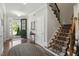 Inviting entryway with hardwood floors, staircase, and access to the front door and other rooms at 1608 Doubles Ct, Raleigh, NC 27609