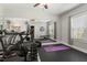 Home gym with workout equipment, mirrors, and natural light from a window at 1608 Doubles Ct, Raleigh, NC 27609
