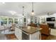Open concept kitchen with center island and adjacent living room and breakfast nook, creating an inviting space at 1608 Doubles Ct, Raleigh, NC 27609