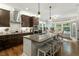 Bright kitchen with stainless appliances, granite countertops, and island seating next to the eat-in breakfast nook at 1608 Doubles Ct, Raleigh, NC 27609
