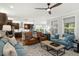 Spacious living room featuring hardwood floors, lots of natural light, and seamless transition to the kitchen at 1608 Doubles Ct, Raleigh, NC 27609
