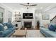 Comfortable living room with a fireplace, built-in shelves, and hardwood flooring at 1608 Doubles Ct, Raleigh, NC 27609