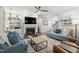 Comfortable living room with a fireplace, built-in shelves, and hardwood flooring at 1608 Doubles Ct, Raleigh, NC 27609