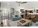 Bright living room featuring hardwood floors, a ceiling fan, and seamless transition to the kitchen at 1608 Doubles Ct, Raleigh, NC 27609