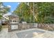 An elaborate outdoor kitchen featuring stone finishes, stainless steel appliances, and a patterned stone patio at 1608 Doubles Ct, Raleigh, NC 27609