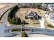 Sprawling property with a grand home, surrounded by lush trees and well-maintained landscaping at 17 Beckwith Ave, Clayton, NC 27527