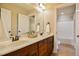 Bright bathroom featuring a double sink vanity with white countertop and wooden cabinetry at 17 Beckwith Ave, Clayton, NC 27527
