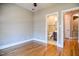 This bedroom features hardwood floors, a ceiling fan, a neutral color palette, and an ensuite bathroom at 17 Beckwith Ave, Clayton, NC 27527