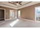 Carpeted main bedroom with tray ceiling, neutral walls and an ensuite bath at 17 Beckwith Ave, Clayton, NC 27527