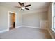 This carpeted bedroom is adjacent to a full bathroom and has a closet for storage at 17 Beckwith Ave, Clayton, NC 27527