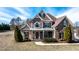 Two-story home with brick and shingle siding, complemented by mature landscaping and a covered front porch at 17 Beckwith Ave, Clayton, NC 27527