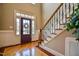 Grand foyer with hardwood floors, staircase with decorative iron balusters, and natural light at 17 Beckwith Ave, Clayton, NC 27527