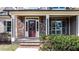 Inviting front porch with brick accents, decorative lighting, and a charming front door at 17 Beckwith Ave, Clayton, NC 27527