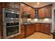 Kitchen with custom wood cabinetry, stainless steel appliances, and granite countertops at 17 Beckwith Ave, Clayton, NC 27527