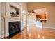 Spacious living room with hardwood floors, fireplace, and view into the kitchen at 17 Beckwith Ave, Clayton, NC 27527