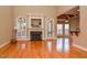 Spacious living room featuring hardwood floors, fireplace, arched doorways, and large windows at 17 Beckwith Ave, Clayton, NC 27527