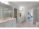 Elegant bathroom features a double vanity, large mirrors, and stylish lighting fixtures at 1783 Ballard Rd # Apex Georgian, Fuquay Varina, NC 27526