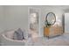 Bedroom sitting area with a chair, accent table, and a view to a bathroom at 1783 Ballard Rd # Apex Georgian, Fuquay Varina, NC 27526