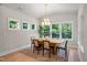Dining room featuring a modern chandelier, a wood table, and lots of natural light at 1783 Ballard Rd # Apex Georgian, Fuquay Varina, NC 27526